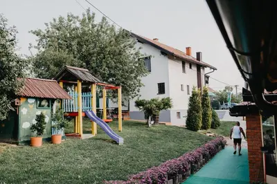 a playground in a yard with a slide at Djedovo ognjište 2