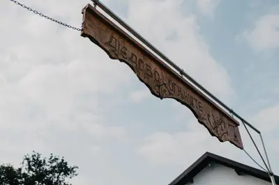 a sign hanging off the side of a building at Djedovo ognjište 2