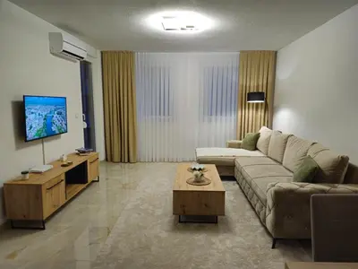 a living room with a couch and a table at Apartman devet rijeka in Sanski most