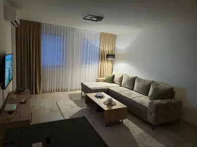 a living room with a couch and a coffee table at Apartman devet rijeka in Sanski most