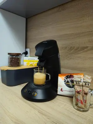a coffee maker sitting on a counter with a cup of coffee at Apartman devet rijeka in Sanski most