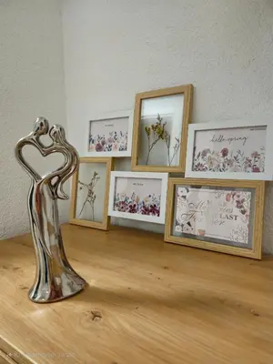 a metal object sitting on a table with pictures at Apartman devet rijeka in Sanski most