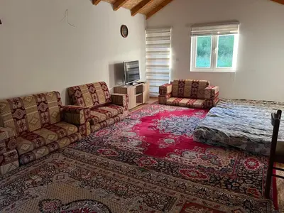 a living room with a couch and a bed at Oaza mira -Trnovo in Ivišovo Greblje