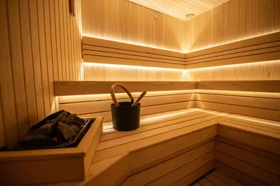 a small wooden sauna with a bucket in it at Hotel President & SPA Maglaj in Maglaj