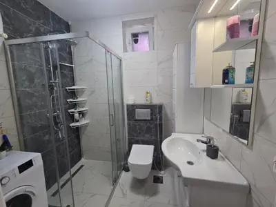 a bathroom with a shower and a toilet and a sink at Apartman Stan na dan Happy Family Bihać in Ribić