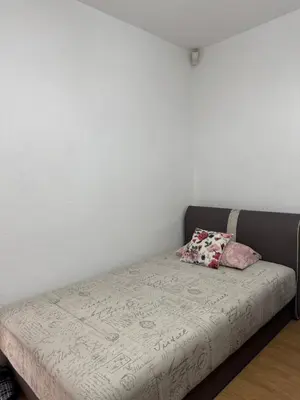 a bed with two pillows on it in a room at Apartman Stan na dan Happy Family Bihać in Ribić
