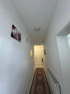a hallway with white walls and a white door at Apartman Stan na dan Happy Family Bihać in Ribić