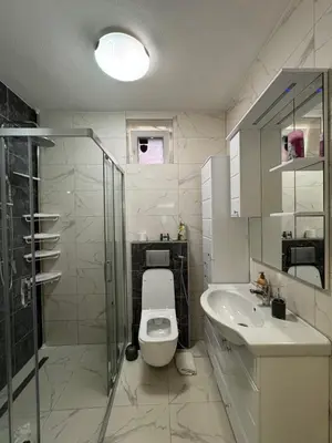 a bathroom with a toilet and a sink and a shower at Apartman Stan na dan Happy Family Bihać in Ribić
