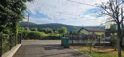 a trash can sitting on the side of a road at Apartman Stan na dan Happy Family Bihać in Ribić