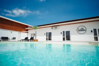 a swimming pool in front of a building at Villa Apartments Blanco - Near Airport Banja Luka in Laktaši