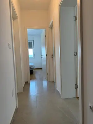 an empty hallway with two doors and a tile floor at Panorama apartman in Banja Luka