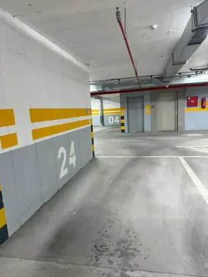 an empty parking garage with the number on the wall at Panorama apartman in Banja Luka