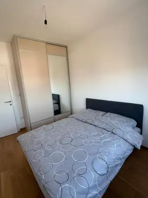 a bedroom with a large bed and a closet at Panorama apartman in Banja Luka