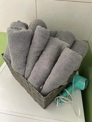 a basket filled with gray towels on a table at Villa Ela in Prijedor