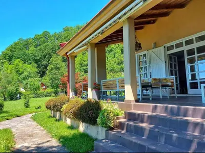 a porch of a house with a bench on it at Villa Ela in Prijedor