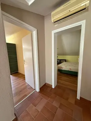 an empty room with a bed and a hallway at Villa Ela in Prijedor