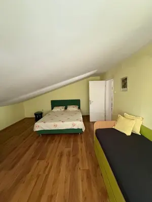 a small room with a bed and a refrigerator at Villa Ela in Prijedor