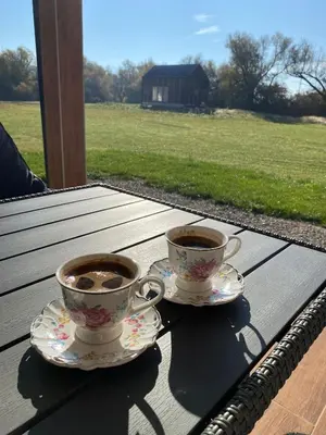 two cups of coffee sitting on a wooden table at Villa Verde House by the River Sturba in Livno