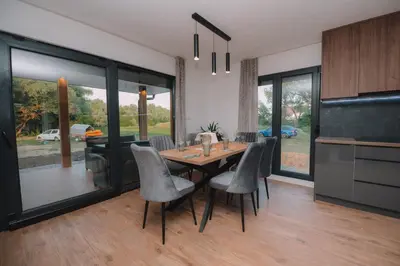 a kitchen and dining room with a table and chairs at Villa Verde House by the River Sturba in Livno