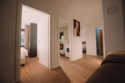 a room with white walls and a wooden floor at Villa Verde House by the River Sturba in Livno