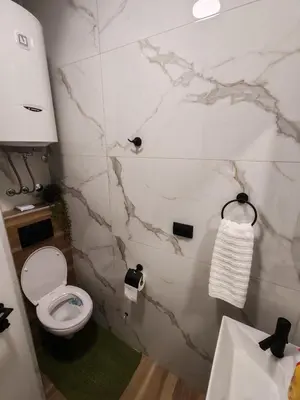 a bathroom with a toilet and a sink at Studio 23 in Banja Luka