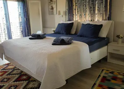 a bedroom with a bed with two towels on it at Motel Ječmište in Tuzla