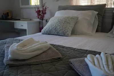 a bed with towels sitting on top of it at Motel Ječmište in Tuzla