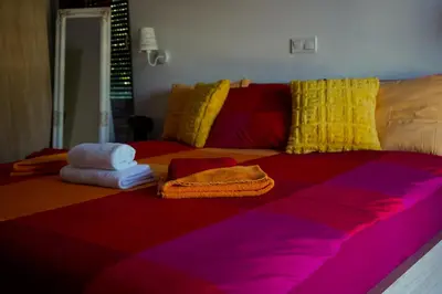 a bed with towels sitting on top of it at Motel Ječmište in Tuzla
