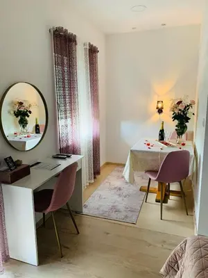 a room with a mirror and a table and chairs at Motel Ječmište in Tuzla