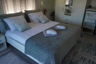 a bedroom with a large bed with towels on it at Motel Ječmište in Tuzla