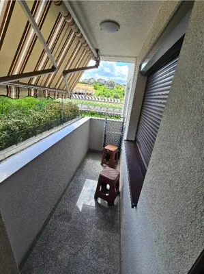 a swing in a room with a window at Stan na Dan Cazin in Ivišovo Greblje