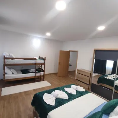 a room with two beds and two bunk beds at Apartman A in Livno