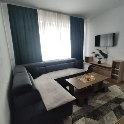 a living room with a couch and a table at Apartman A in Livno
