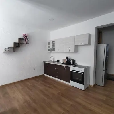 a kitchen with a stove and a refrigerator at Apartman A in Livno