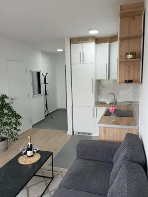 a living room with a couch and a table at Apartman Sunset Doboj in Doboj