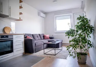 a living room with a couch and a table at Apartman Sunset Doboj in Doboj