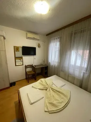 a bedroom with a bed with a robe on it at Elas in Banja Luka