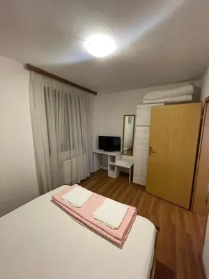 a bedroom with a bed with a pink towel on it at Elas in Banja Luka