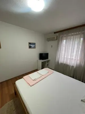a bedroom with a white bed and a window at Elas in Banja Luka