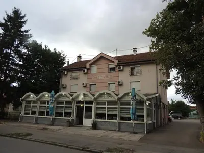 a building with blue flags in front of it at Elas in Banja Luka