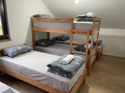 a room with three bunk beds with pillows at Kuća za odmor Ana in Zenica