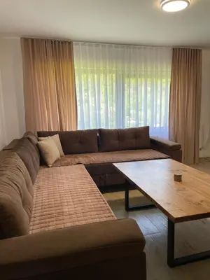 a living room with a couch and a coffee table at Kuća za odmor Ana in Zenica