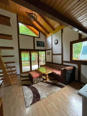 a living room with a couch and a table at UNA Dream in Ivišovo Greblje