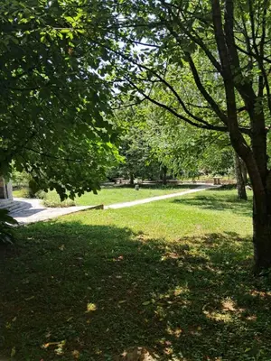 a park with trees and a path in the grass at Al-Batten Vila Bihac in Bare