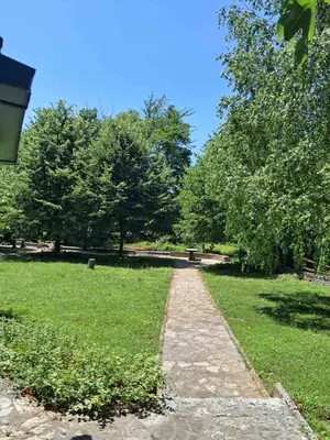 a path through a park with trees and grass at Al-Batten Vila Bihac in Bare