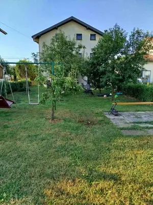 a yard with a swing set and a tree at Apartmani LIDER Visoko in Visoko