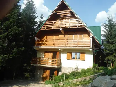 a large house with wooden balconies on the side of it at Holiday Home Villa Snježina in Vlasic