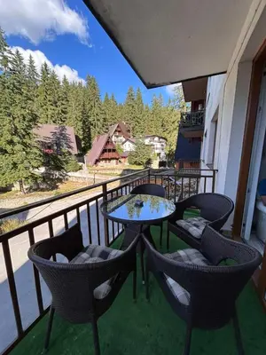 a balcony with chairs and a table on a balcony at Apartment Alisa in Vlasic