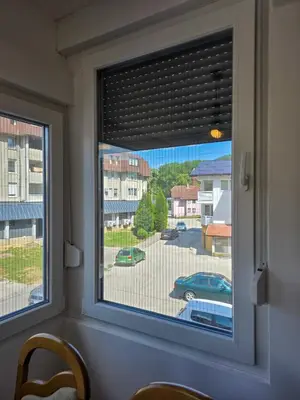 a window with a view of a parking lot at Urban Nest in Jajce