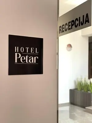a sign for a hotel petterar on a wall in a room at Hotel Petar in Kotor-Varoš